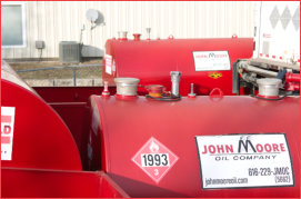 Shiny bright red fuel tanks for rent from John Moore Oil Company