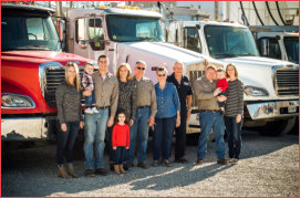 Four generations of the Moore family standing in front of their fleet of fuel delivery trucks in downtown Blue Springs Missouri